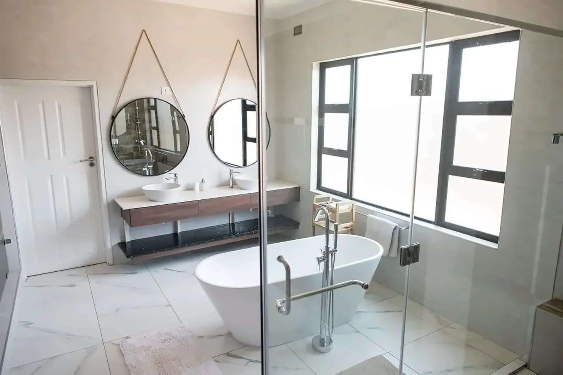 Bathroom with freestanding bath and floating timber vanity
